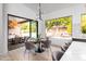Dining area opens to an outdoor living space and features a modern chandelier and seating for four at 6438 E Montreal Pl, Scottsdale, AZ 85254