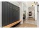 Stylish entryway featuring a coat rack with a bench, decorative accents, and modern lighting at 6438 E Montreal Pl, Scottsdale, AZ 85254