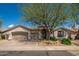 Charming single-story home featuring a well-manicured front yard and a three-car garage at 6438 E Montreal Pl, Scottsdale, AZ 85254