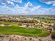 Bird's-eye view of a lush golf course showcasing neatly manicured greens, sand traps, and distant mountains at 6438 E Montreal Pl, Scottsdale, AZ 85254