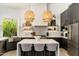 Modern kitchen with center island, pendant lighting, open shelving, and stainless steel appliances at 6438 E Montreal Pl, Scottsdale, AZ 85254