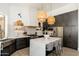 Well-equipped kitchen with stainless appliances, pendant lights, ample storage and center island with seating at 6438 E Montreal Pl, Scottsdale, AZ 85254
