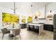 Bright kitchen with island, dining area, stainless steel appliances, and dark cabinets at 6438 E Montreal Pl, Scottsdale, AZ 85254