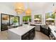 Bright kitchen with island and sink, plus a view to the outdoor pool area from a large window at 6438 E Montreal Pl, Scottsdale, AZ 85254