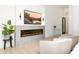 Bright living room featuring a modern fireplace, stylish seating, and contemporary decor for a welcoming ambiance at 6438 E Montreal Pl, Scottsdale, AZ 85254
