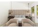 The serene main bedroom features decorative lighting, a padded headboard, and stylish bedside tables at 6438 E Montreal Pl, Scottsdale, AZ 85254