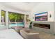 This bedroom suite boasts a fireplace, a TV, and sliding glass doors to the private pool at 6438 E Montreal Pl, Scottsdale, AZ 85254