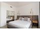 Stylish main bedroom features a gray upholstered bed frame and dual sconce lighting at 6438 E Montreal Pl, Scottsdale, AZ 85254