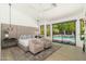 Bright, airy main bedroom suite boasts modern furnishings, sitting area, and walk-out access to the pool at 6438 E Montreal Pl, Scottsdale, AZ 85254