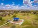 Aerial shot of a park playground with a blue awning surrounded by green grass and neighborhood homes at 6438 E Montreal Pl, Scottsdale, AZ 85254