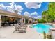 Backyard pool with lounge chairs, a jacuzzi, and a covered patio for relaxing at 6438 E Montreal Pl, Scottsdale, AZ 85254