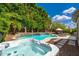Outdoor oasis featuring a sparkling pool, hot tub, waterfall, and spacious patio area with lounge furniture at 6438 E Montreal Pl, Scottsdale, AZ 85254
