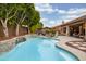 Gorgeous pool with a rock waterfall and a meticulously landscaped yard at 6438 E Montreal Pl, Scottsdale, AZ 85254