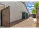 House side yard, featuring a gravel pathway and utilitarian items obscured by a screen at 6438 E Montreal Pl, Scottsdale, AZ 85254