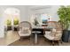 Cozy sitting area with unique chairs, a stylish mirror, and views into the kitchen at 6438 E Montreal Pl, Scottsdale, AZ 85254