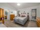 Bright main bedroom featuring tile floors, a ceiling fan, and ensuite bathroom at 6632 E Fairbrook Cir, Mesa, AZ 85205