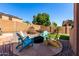 Inviting backyard with colorful Adirondack chairs around a cozy fire pit on a stone patio at 7150 W Avenida Del Rey --, Peoria, AZ 85383