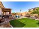 Entertainer's backyard with a pool, seating, barbecue, patio, and artificial turf for games at 7150 W Avenida Del Rey --, Peoria, AZ 85383
