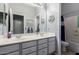Bathroom featuring double sinks, a large mirror, and nautical themed decor at 7150 W Avenida Del Rey --, Peoria, AZ 85383