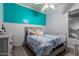 Bedroom with a blue accent wall, a bed with blue and white patterned bedding, and a grey dresser at 7150 W Avenida Del Rey --, Peoria, AZ 85383