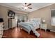Relaxing bedroom with a ceiling fan, hardwood floors, and natural light at 7150 W Avenida Del Rey --, Peoria, AZ 85383