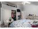 Bedroom featuring a ceiling fan, a closet, a TV, a dresser, and a work desk at 7150 W Avenida Del Rey --, Peoria, AZ 85383