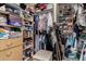 Walk-in closet with built-in shelving, hanging rods, drawers, and a cushioned ottoman at 7150 W Avenida Del Rey --, Peoria, AZ 85383
