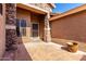 Covered front porch with stone pillars and a decorative security door at 7150 W Avenida Del Rey --, Peoria, AZ 85383