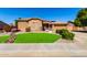 Charming single-story home with a well-manicured lawn and stone accents at 7150 W Avenida Del Rey --, Peoria, AZ 85383
