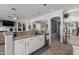 Spacious kitchen with stainless steel appliances, white cabinets, and a large island with sink at 7150 W Avenida Del Rey --, Peoria, AZ 85383