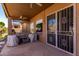 Covered patio featuring stone flooring, metal screen doors, and outdoor furniture at 7150 W Avenida Del Rey --, Peoria, AZ 85383
