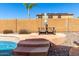 Poolside view of the backyard showing a patio, picnic table, and privacy wall at 7150 W Avenida Del Rey --, Peoria, AZ 85383