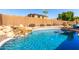 Stunning backyard oasis featuring a sparkling pool with rock waterfall and ample lounging space at 7150 W Avenida Del Rey --, Peoria, AZ 85383