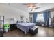 Stylish bedroom featuring a ceiling fan and neutral walls with hardwood floors at 7363 E Plata Ave, Mesa, AZ 85212