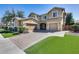 Beautiful two-story home featuring a three-car garage and a well-manicured front yard at 7363 E Plata Ave, Mesa, AZ 85212
