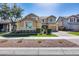 Charming two-story home featuring a well-manicured lawn, stone accents, and inviting curb appeal at 7363 E Plata Ave, Mesa, AZ 85212