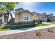 Inviting home showcasing a well-maintained lawn, stone accents, and an attached garage at 7363 E Plata Ave, Mesa, AZ 85212