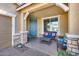 Cozy front porch with comfortable seating and a welcoming blue door at 7363 E Plata Ave, Mesa, AZ 85212
