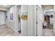 Hallway view with neutral walls, decorative paintings, tiled floors, and doorways to different rooms at 7363 E Plata Ave, Mesa, AZ 85212