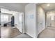 Hallway showing access to rooms, with an open doorway to an office or den area at 7363 E Plata Ave, Mesa, AZ 85212