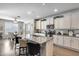 Bright kitchen with stainless steel appliances, granite counters, white cabinets, and a breakfast bar at 7363 E Plata Ave, Mesa, AZ 85212