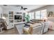 Bright living room with built-in shelving, a ceiling fan, and large windows overlooking the yard at 7363 E Plata Ave, Mesa, AZ 85212