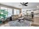 Bright living area with large windows, ceiling fan and open to the kitchen at 7363 E Plata Ave, Mesa, AZ 85212