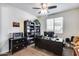Comfortable home office featuring a ceiling fan, desk, shelving and a window providing natural light at 7363 E Plata Ave, Mesa, AZ 85212