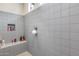 The tile shower features a built-in bench for a touch of elegance and convenience at 7363 E Plata Ave, Mesa, AZ 85212