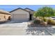 Charming single-story home featuring a neutral color palette, desert landscaping, and a two-car garage at 8007 S 69Th Dr, Laveen, AZ 85339