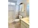 Well-lit bathroom with a shower, vanity, and mirrored cabinet for storage at 8303 E Edgewood Ave, Mesa, AZ 85208