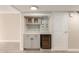 Cozy wet bar with gray cabinetry, wine fridge, and tiled backsplash at 835 N Granite Reef Rd # 29, Scottsdale, AZ 85257