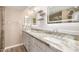 Bright bathroom featuring double sinks, marble countertops, modern light fixtures, and sleek shelving at 835 N Granite Reef Rd # 29, Scottsdale, AZ 85257