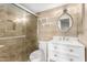 Stylish bathroom featuring a glass-enclosed shower and an oval mirror at 835 N Granite Reef Rd # 29, Scottsdale, AZ 85257